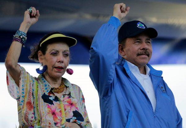 Nicaraguan President Daniel Ortega and his wife, Vice-President Rosario Murillo, raise their fists during the commemoration of the 51st anniversary of the Pancasan guerrilla campaign in Managua, on Aug. 29, 2018. (Inti Ocon/AFP/Getty Images)