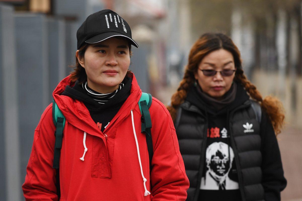 Li Wenzu (L), the wife of detained human rights lawyer Wang Quanzhang, walks on the outskirts of Beijing to Tianjin, where she believes her husband is being held, on April 5, 2018. (Greg Baker/AFP/Getty Images)