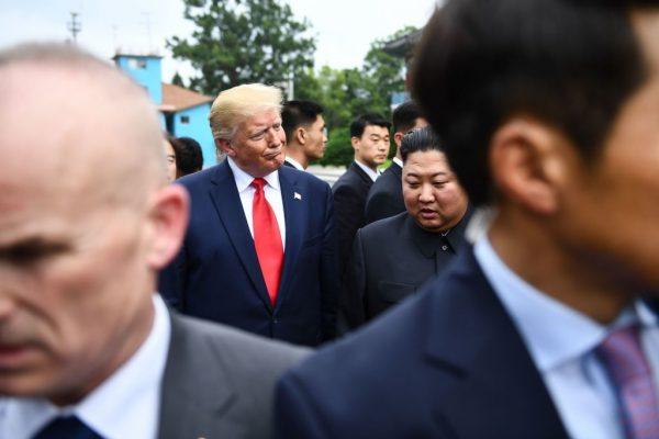 North Korea's dictator Kim Jong Un (centre R) and US President Donald Trump (centre L) walk to attend a meeting on the south side of the Military Demarcation Line. (BRENDAN SMIALOWSKI/AFP/Getty Images)