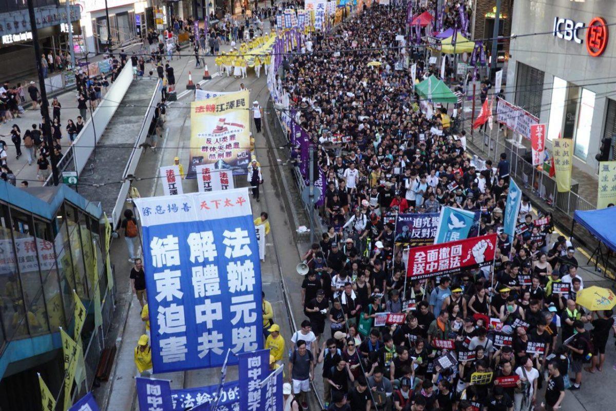 Falun Gong practitioners take part in a march in Hong Kong on July 1, 2019. (Yu Gang/The Epoch Times)