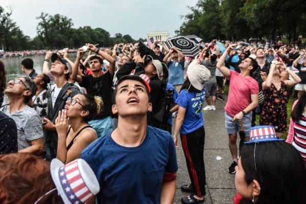 People cheer during a fly over on the National Mall during President Donald Trump's speech during Fourth of July festivities in Washington, D.C. on July 4, 2019. (Stephanie Keith/Getty Images)