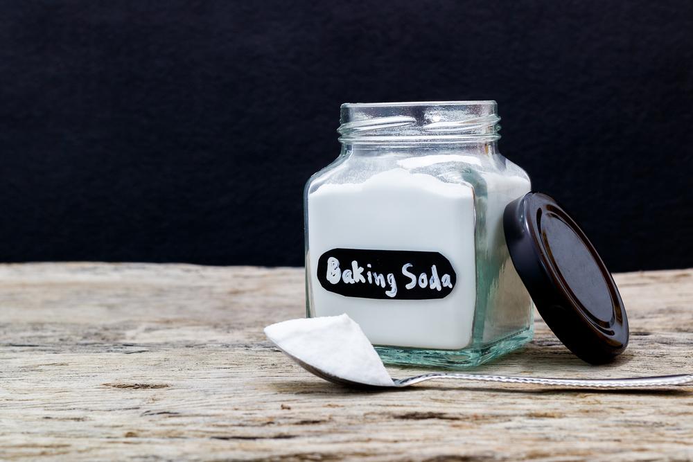 Illustration - Shutterstock | <a href="https://www.shutterstock.com/image-photo/jar-spoonful-baking-soda-on-wooden-764319937?studio=1">Maderla</a>