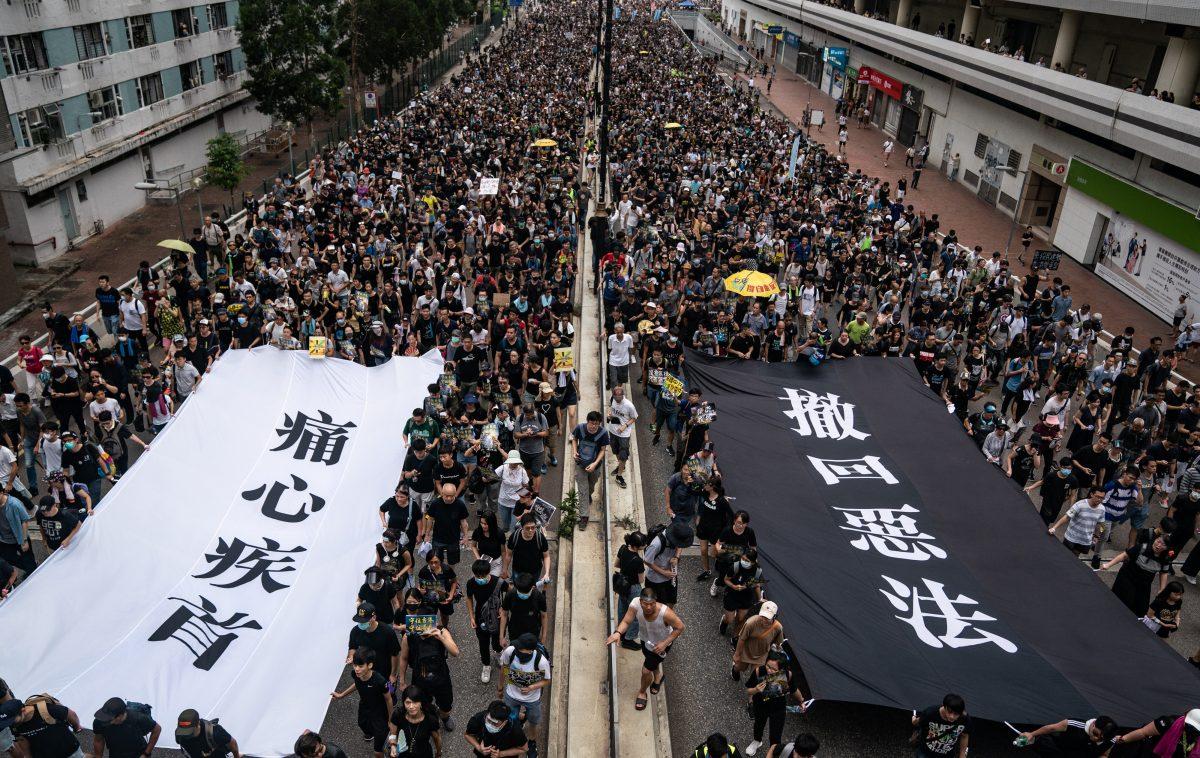 Protesters hold banners as they take part in a march against a controversial extradition bill in the Sha Tin district of Hong Kong, on July 14, 2019. (Anthony Kwan/Getty Images)
