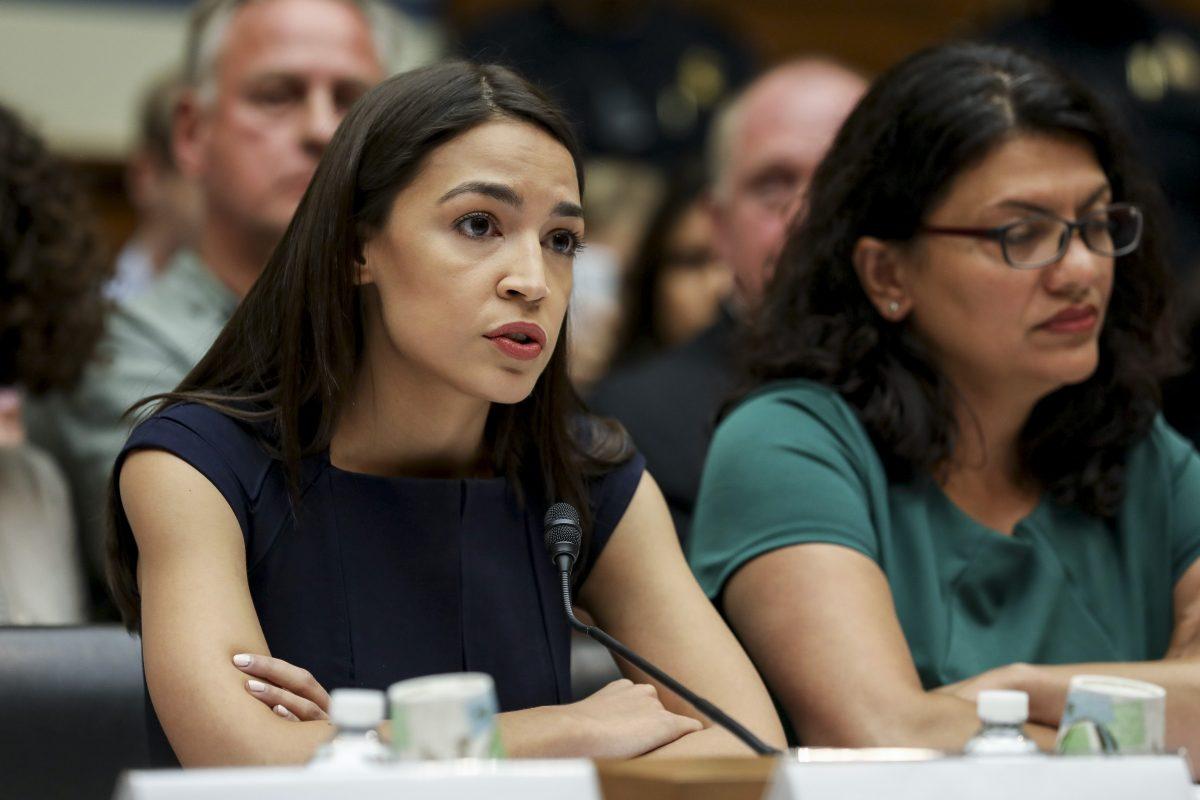 L-R: Reps. Alexandria Ocasio-Cortez (D.N.Y.) and Rashida Tlaib (D-Mich.), members of the Democratic Socialists of America, at a House Committee on Oversight and Reform hearing, in Washington on July 12, 2019. (Charlotte Cuthbertson/The Epoch Times)
