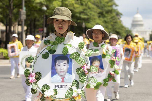Falun Gong practitioners take part in a parade commemorating the 20th anniversary of the persecution of Falun Gong in China, in Washington on July 18, 2019. (Samira Bouaou/The Epoch Times)