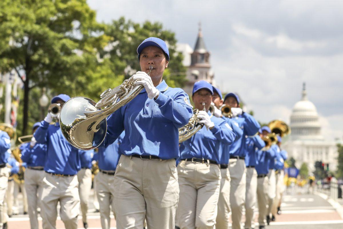 Falun Gong practitioners march from the U.S. Capitol to the Washington Monument commemorating the 20th anniversary of the persecution of Falun Gong in China, on July 18, 2019. (Samira Bouaou/The Epoch Times)
