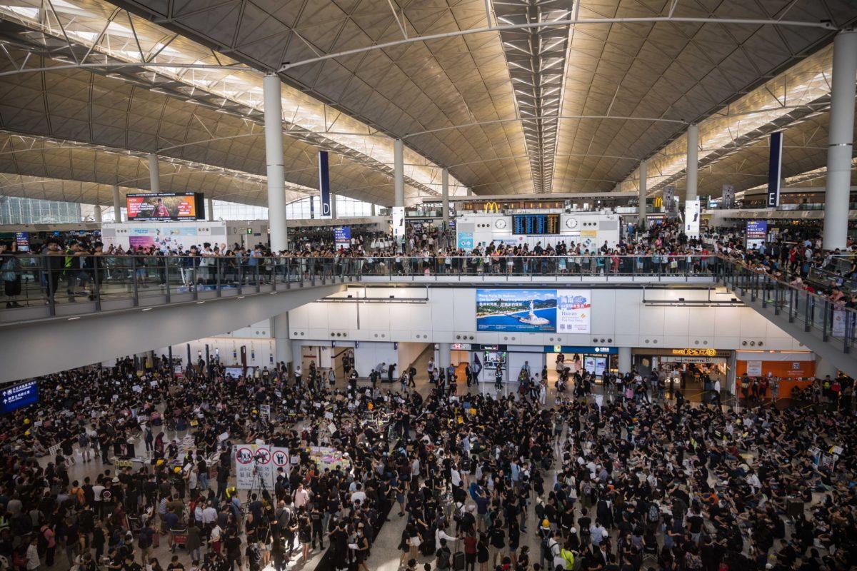 Protesters rally against a controversial extradition bill in the arrivals hall at the international airport in Hong Kong on July 26, 2019. (Anthony Wallace/AFP/Getty Images)