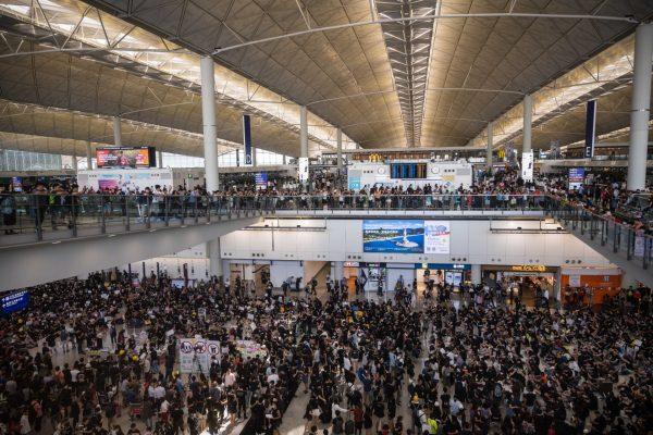 Protesters rally against a controversial extradition bill in the arrivals hall at the international airport in Hong Kong on July 26, 2019. (Anthony Wallace/AFP/Getty Images)