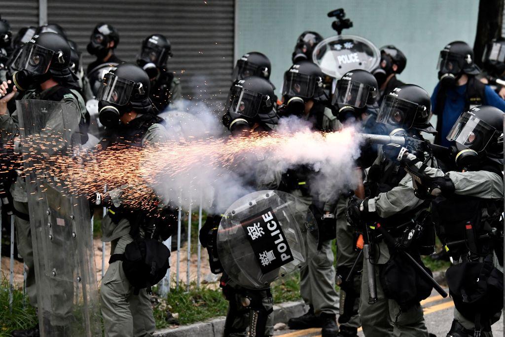 A policeman fires tear gas to disperse protesters during a demonstration in the district of Yuen Long in Hong Kong on July 27, 2019. (Anthony Wallace/AFP/Getty Images)