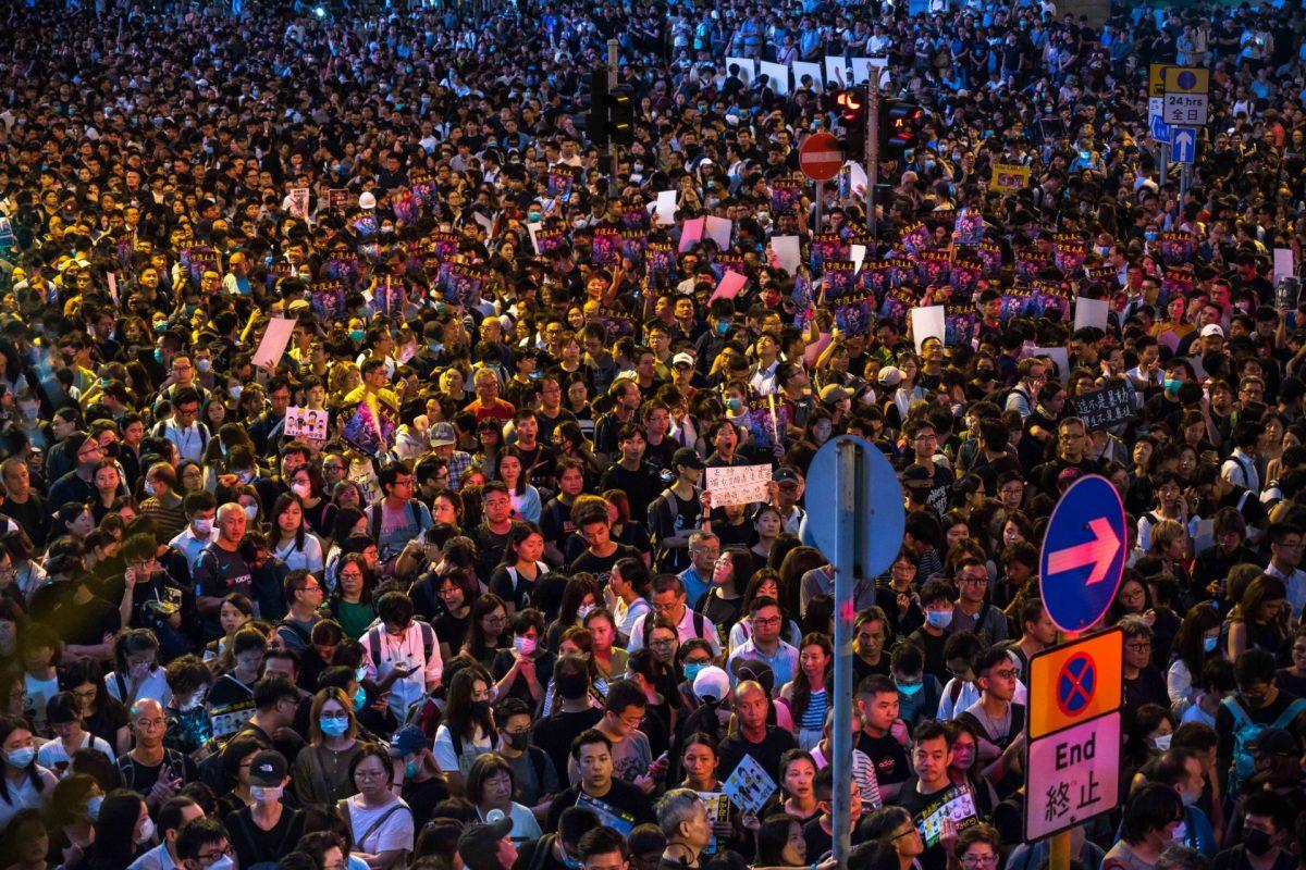 Demonstrators gather and hold placards during a rally organized by civil servants at Chater Garden in the Central district in Hong Kong, on Aug. 02, 2019. (Billy H.C. Kwok/Getty Images)