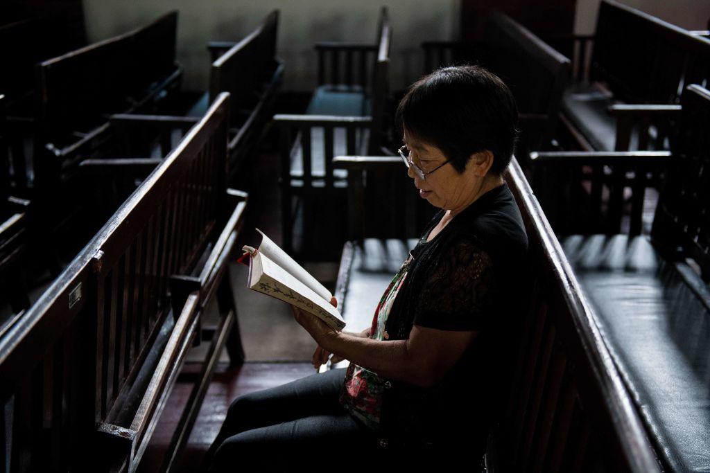 A woman reads the Bible at the Christian Glory church in Wuhan, a city in China's Hebei Province, on Sept. 23, 2018. (Nicolas Asfouri/AFP/Getty Images)