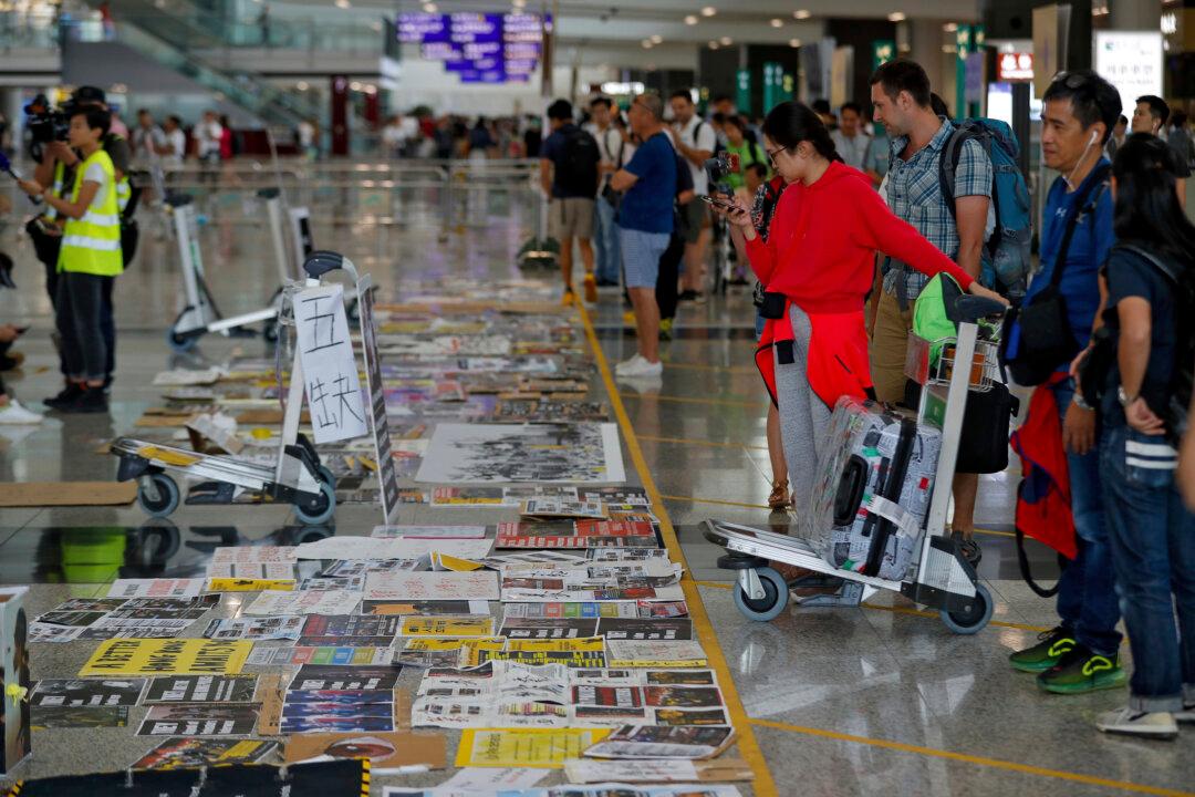 Flights Restart at Hong Kong Airport as Protesters Apologize