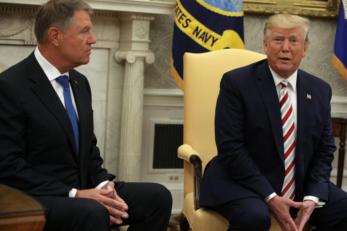 President Donald Trump speaks to members of the media as President of Romania Klaus Iohannis listens in the Oval Office of the White House in Washington on Aug. 20, 2019. (Alex Wong/Getty Images)