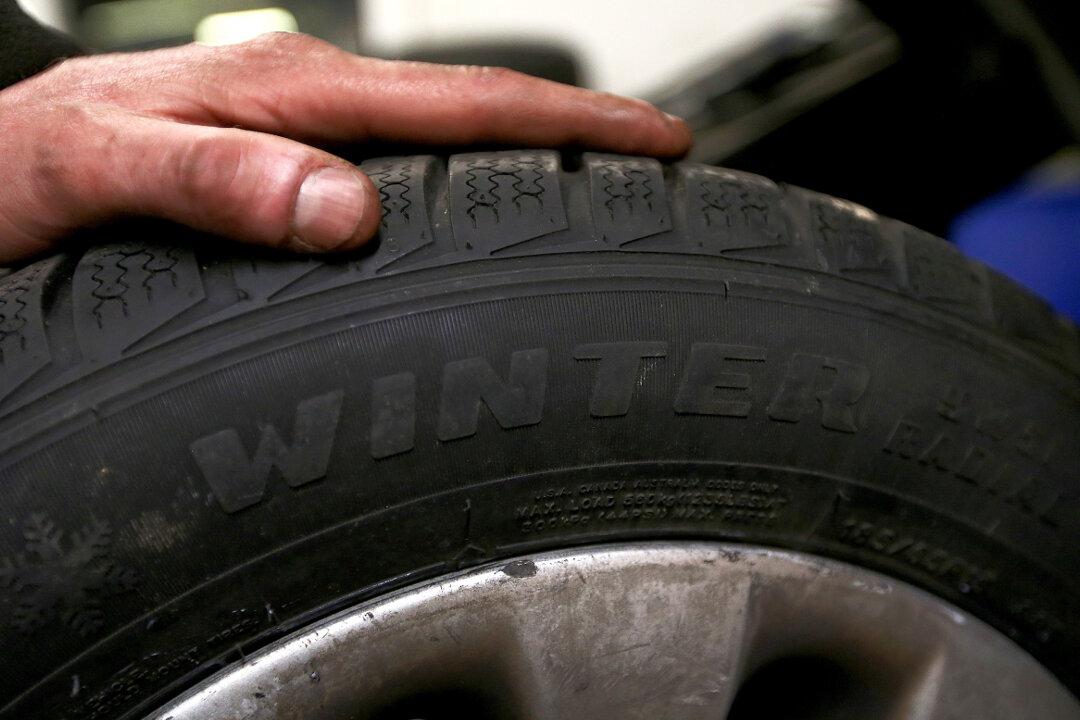 Car Mechanic Bounces Tires Like a Basketball