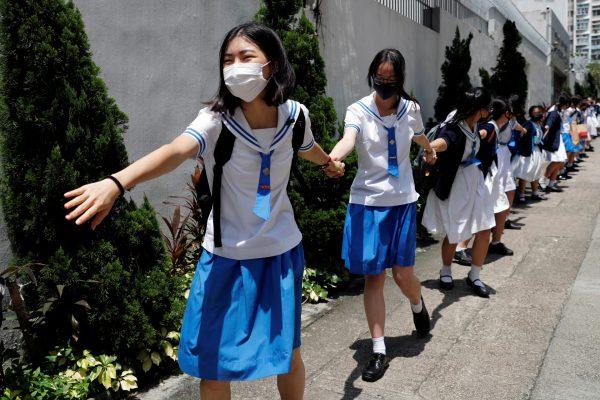Secondary school students form a human chain against extradition bill in Hong Kong, on Sept. 3, 2019. (Tyrone Siu/Reuters)