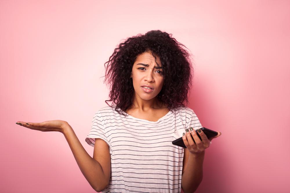 Illustration - Shutterstock | <a href="https://www.shutterstock.com/image-photo/young-woman-mobile-phone-confused-isolated-785597788">Paranamir</a>