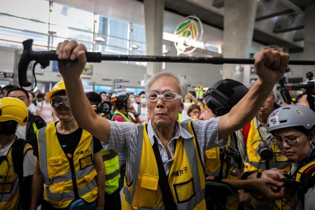 A Group of Parents and Elderly Protect Hong Kong Protesters During Police Clashes