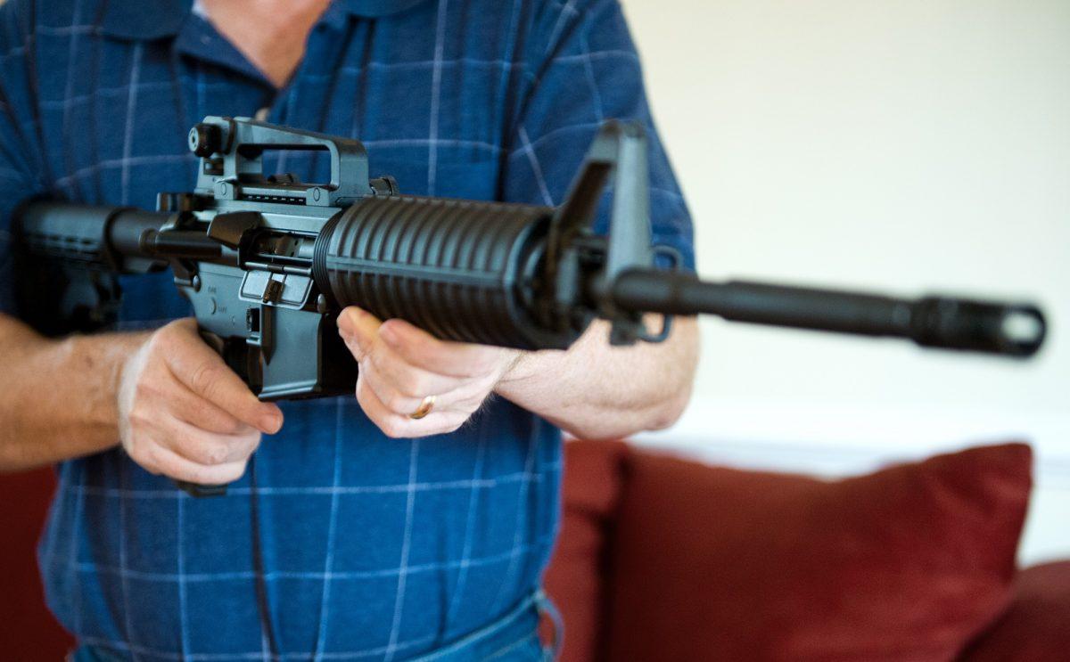This February 4, 2013 photo illustration in Manassas, Virginia, shows a man holding a Colt AR-15 semi-automatic rifle. (Karen Bleier/AFP/Getty Images)