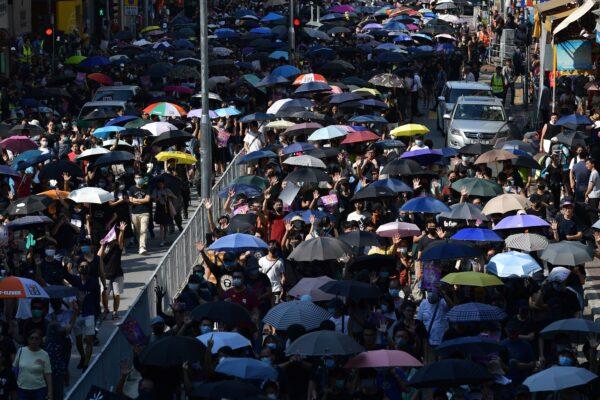 Demonstrators hold up their hands to symbolize the five demands that protesters are asking for, as they take part in a pro-democracy march in Hong Kong's Tuen Mun district on Sept. 21, 2019. (Nicolas Asfouri/AFP/Getty Images)