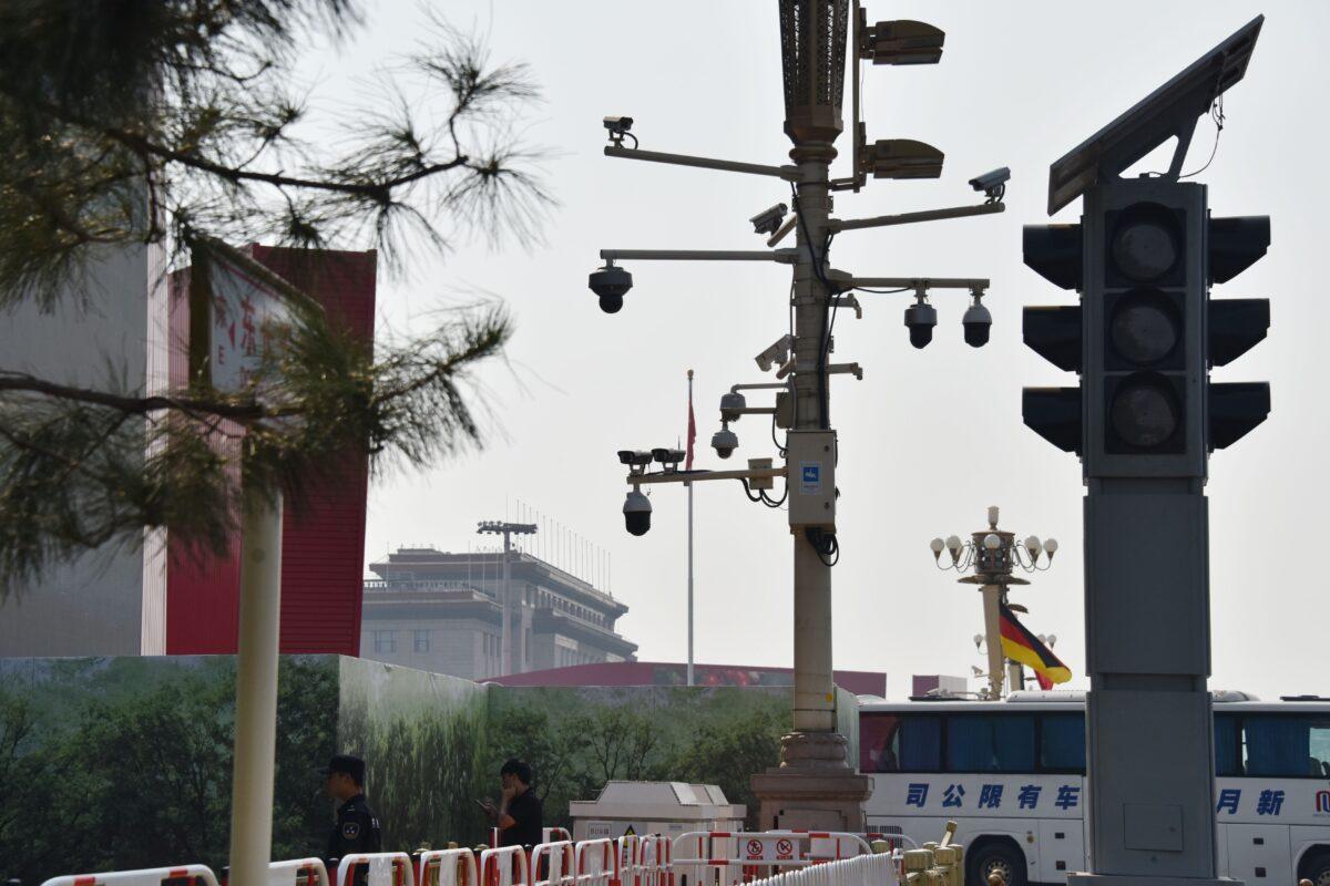 Security guards patrol below surveillance cameras on a corner of Tiananmen Square in Beijing on Sept. 6, 2019. (Greg Baker/AFP/Getty Images)