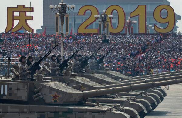 Chinese soldiers sit atop tanks as they drive in a parade to celebrate the 70th Anniversary of the founding of the People's Republic of China in 1949, at Tiananmen Square in Beijing, China on October 1, 2019. (Kevin Frayer/Getty Images)