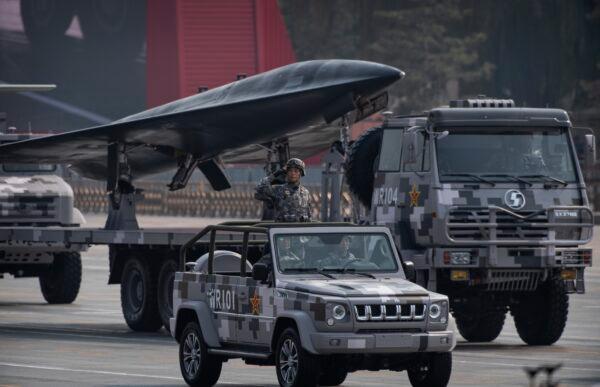 A Chinese soldier salutes in front of a drone during a parade to celebrate the 70th Anniversary of the founding of the People's Republic of China at Tiananmen Square in 1949 in Beijing, China on October 1, 2019. (Kevin Frayer/Getty Images)