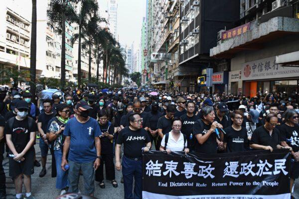 Protesters take part in a rally in the Wanchai district in Hong Kong on the 70th anniversary of communist China's founding, Oct. 1, 2019. Police fanned out across Hong Kong in a bid to deter pro-democracy protests. (Anthony Wallace/AFP/Getty Images)