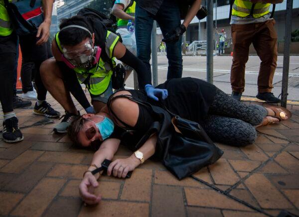 A woman reacts after being tear-gassed by the Admiralty MTR station in Hong Kong on Oct. 1, 2019, as the city observes the National Day holiday to mark the 70th anniversary of communist China's founding. (Mark Ralston/AFP/Getty Images)