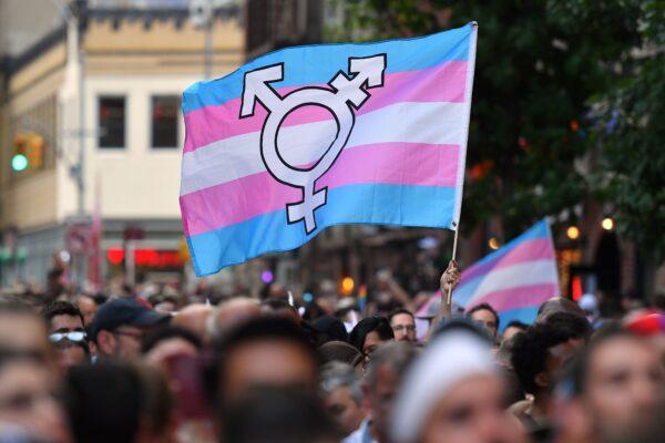 A person holds a transgender pride flag in a file photograph. (Angela Weiss/AFP/Getty Images)