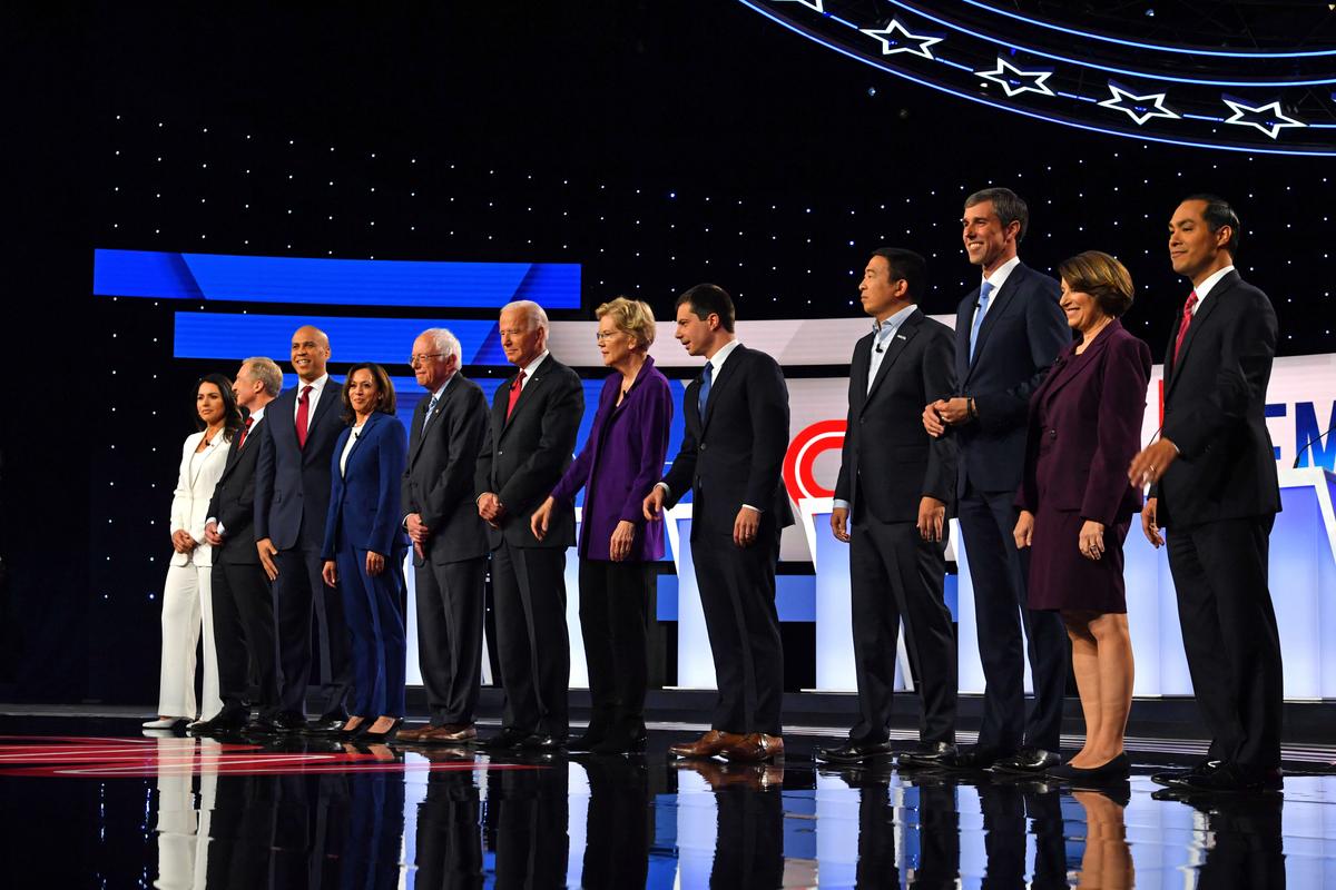 (From L) Democratic presidential hopefuls, Rep. Tulsi Gabbard (D-Hawaii), billionaire Tom Steyer, Sen. Cory Booker (D-N.J.), Sen. Kamala Harris (D-Calif.), Sen. Bernie Sanders (D-Vt.), former Vice President Joe Biden, Sen. Elizabeth Warren (D-Mass.), Mayor of South Bend Pete Buttigieg, entrepreneur Andrew Yang, former Representative for Texas Beto O'Rourke, Sen. Amy Klobuchar (D-Minn.), former Secretary of Housing and Urban Development Julian Castro arrive on stage for the fourth Democratic primary debate of the 2020 presidential campaign season co-hosted by The New York Times and CNN at Otterbein University in Westerville, Ohio on Oct. 15, 2019. (Photo by Nicholas Kamm/AFP via Getty Images)