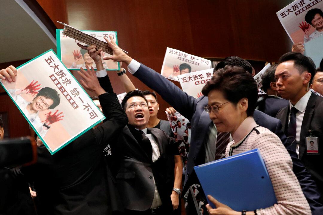 Hong Kong Leader Jeered out of Legislative Council During Policy Speech