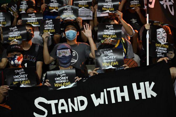 Protesters shout slogans as they hold flyers at the Southorn Playground in Hong Kong on Oct. 15, 2019. (Anthony Wallace/AFP via Getty Images)