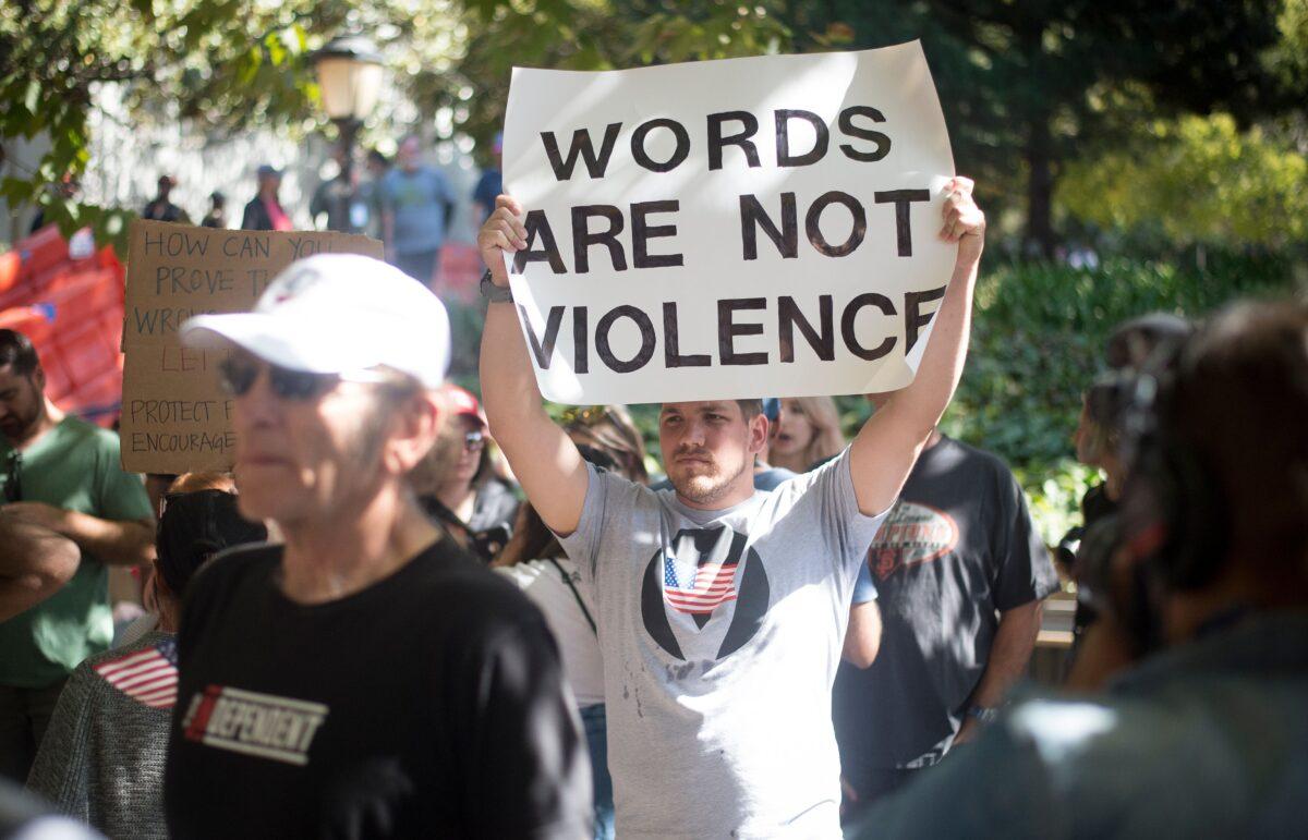 Counter-protesters hold up signs while waiting for conservative commentator Milo Yiannopoulos to arrive at the University of California–Berkeley campus on Sept. 24, 2017. (Josh Edelson/AFP via Getty Images)