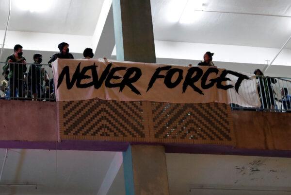 Attendees hang a banner at a gathering, paying tribute to Chow Tsz-lok, 22, a university student who died after he fell during a protest in Hong Kong, on Nov. 8, 2019. (Shannon Stapleton/Reuters)