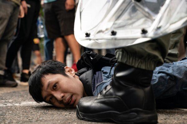 A pro-democracy protester is detained by riot police in Hong Kong, on Nov. 11, 2019. (Anthony Kwan/Getty Images)
