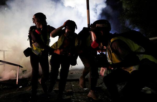 Protesters run during a standoff with riot police at the Chinese University of Hong Kong, Hong Kong, on Nov. 12, 2019. (Tyrone Siu/Reuters)