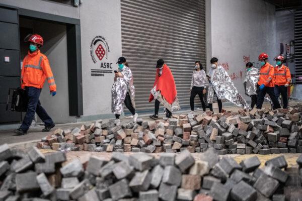 Medics lead away protesters at Hong Kong Polytechnic University on Nov. 20, 2019. (Laurel Chor/Getty Images)