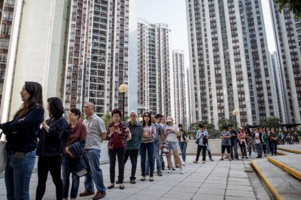 People line up at a polling station to vote in the Hong Kong District Council elections in Hong Kong, on Nov. 24, 2019. (Chris McGrath/Getty Images)