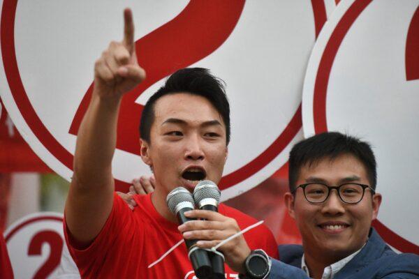 Pro-democracy district council candidate Jimmy Sham (L) speaks with Raphael Wong, vice-chairman of the League of Social Democrats (LSD), at a public housing estate during district council elections in the Sha Tin district of Hong Kong on Nov. 24, 2019. (Philip Fong/AFP via Getty Images)