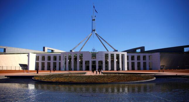 Tourists walk around the forecourt of Australia's Parliament House in Canberra, Australia, on Oct. 16, 2017. (David Gray/Reuters)