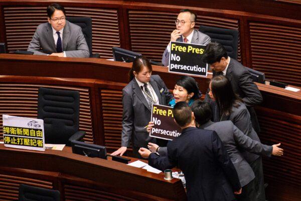 Hong Kong pro-democracy legislator Claudia Mo (R) is surrounded by security as she shouts "Free press! No Persecution!" as Chief Executive Carrie Lam (not pictured) arrives to deliver her policy address at the Legislative Council (Legco) in Hong Kong on Oct. 10, 2018. (Anthony Wallace/AFP via Getty Images)