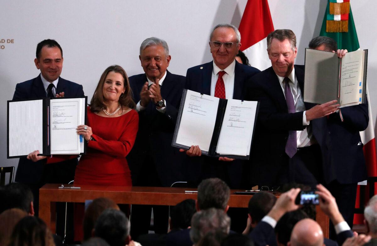 Mexico's Treasury Secretary Arturo Herrera (L) Deputy Prime Minister of Canada Chrystia Freeland (2L) Mexico's President Andres Manuel Lopez Obrador (C) Mexico's top trade negotiator Jesus Seade (2R) and U.S. Trade Representative Robert Lighthizer, hold the documents after signing an update to the North American Free Trade Agreement, at the national palace in Mexico City, Mexico, on Dec. 10. 2019. (Marco Ugarte/AP Photo)