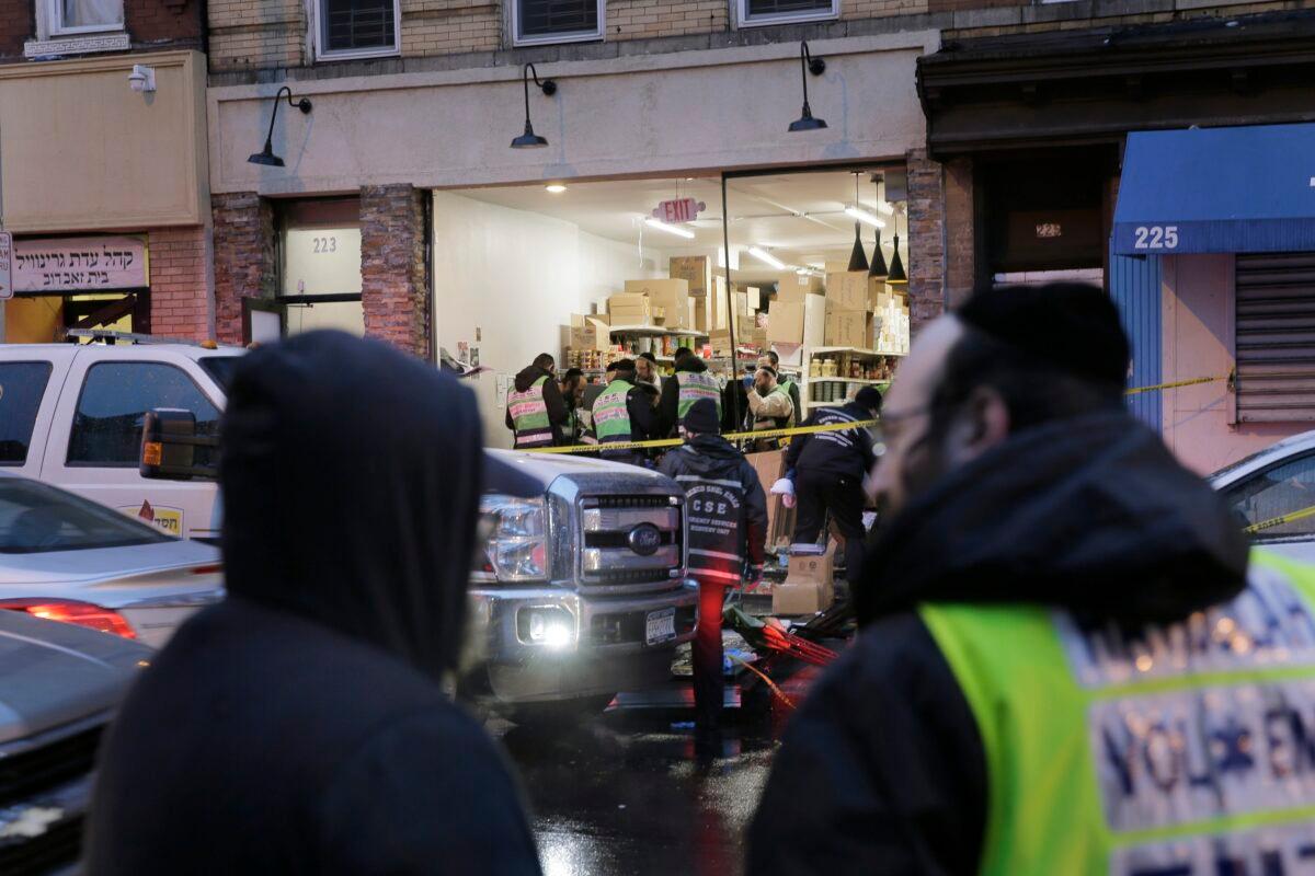 Emergency responders work at a kosher supermarket, the site of a shooting in Jersey City, N.J., on Dec. 11, 2019. Jersey City Mayor Steven Fulop said authorities believe gunmen targeted the market during a shooting that killed multiple people. (Seth Wenig/AP Photo)