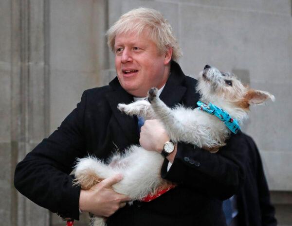 Britain's Prime Minister Boris Johnson leaves a polling station at the Methodist Central Hall, with his dog Dilyn, after voting in the general election in London, Britain, on Dec.12, 2019. (Henry Nicholls/Reuters)