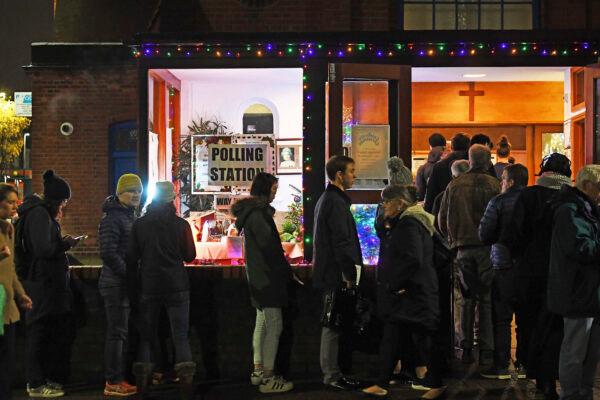 Voters queue outside St Andrews Church polling station in Balham, south London, just hours before voting closes for the 2019 General Election, on Dec. 12, 2019. (Victoria Jones/PA via AP)