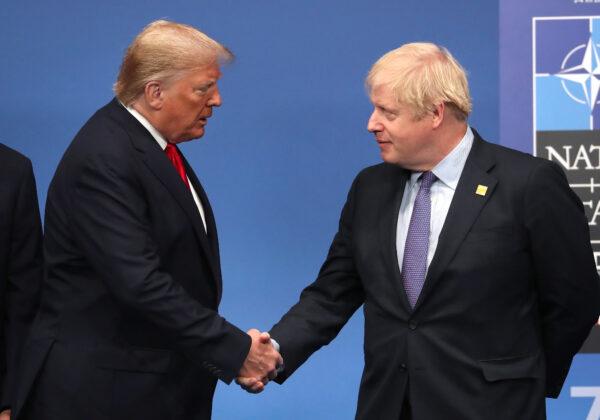 British Prime Minister Boris Johnson shakes hands with President Donald Trump onstage during the annual NATO heads of government summit in Watford, England, on Dec. 4, 2019. (Steve Parsons/WPA Pool/Getty Images)