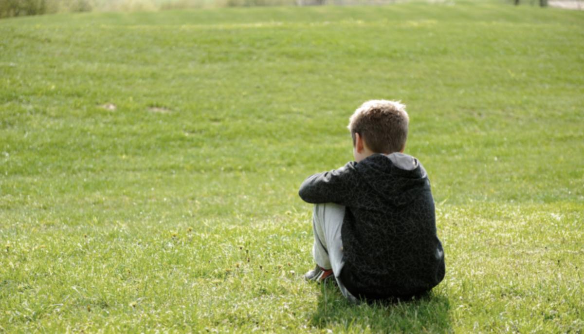 Heartwarming Picture Captures Cop Comforting Non-verbal Boy With Autism During a Meltdown