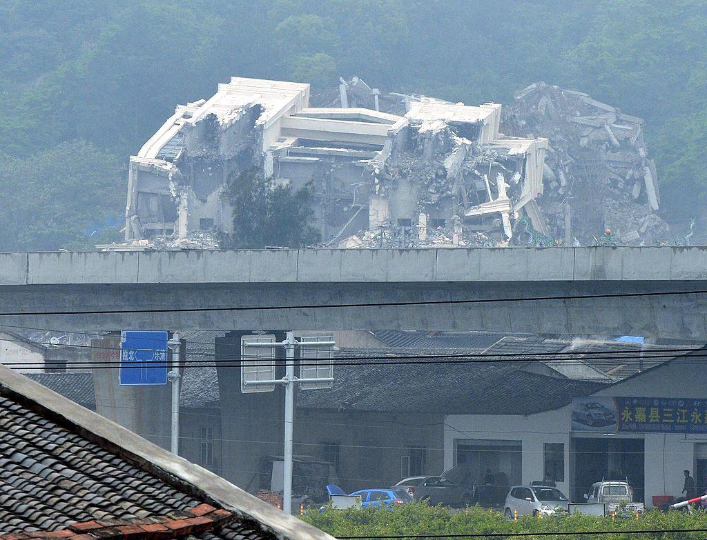Christian church in the town of Oubei, outside the city of Wenzhou show Chinese authorities demolishing it on April 28, 2014. (©Getty Images | <a href="https://www.gettyimages.com/detail/news-photo/this-image-taken-on-april-30-2014-shows-a-christian-church-news-photo/487380723">MARK RALSTON/AFP</a>)