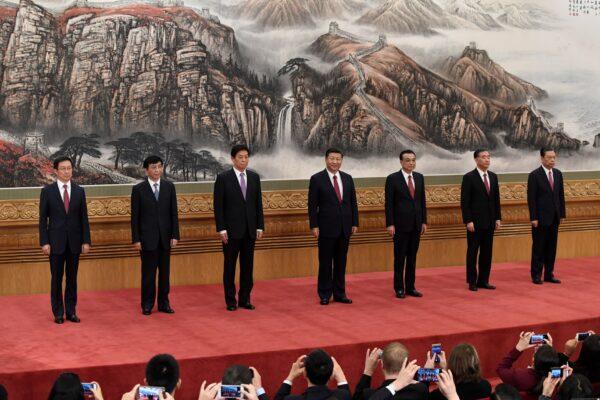 The Chinese Communist Party's Politburo Standing Committee members (L-R): Han Zheng, Wang Huning, Li Zhanshu, Chinese leader Xi Jinping, premier Li Keqiang, Wang Yang, and Zhao Leji meet the press at the Great Hall of the People in Beijing on October 25, 2017. (WANG ZHAO/AFP via Getty Images)