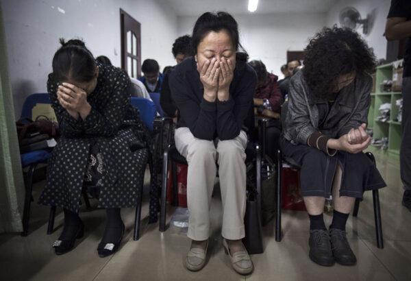 Chinese Christians pray during a service at an underground independent Protestant Church on Oct. 12, in Beijing. China, an officially atheist country, places a number of restrictions on Christians and allows legal practice of the faith only at state-approved churches. (Kevin Frayer/Getty Images)